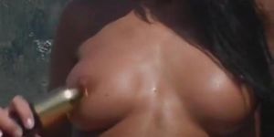 Babe masturbates in the pool with a golden Dildo