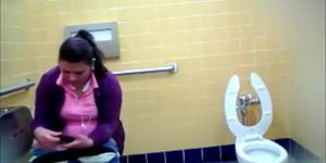 Mature Mexican woman goes pee in a public bathroom