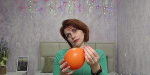 Redhead Milf plays with balloon on webcam