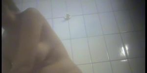 A girl is undressing in the swimming pool changing room