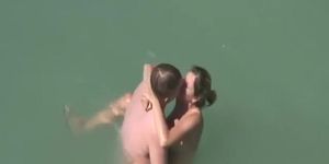 Beach couple sex in the sea