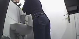 Pissing and fixing makeup in the mirror
