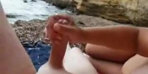 Couple relaxes and lucky guy gets good handjob