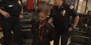 2 female officers apprehend a black suspect to screw
