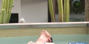 Big breast brunette plays in water