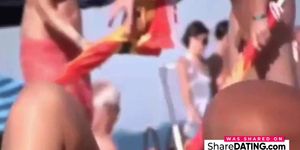 a couple masturbates on nudist beach