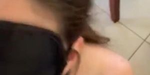 Blindfolded slave sucking dick