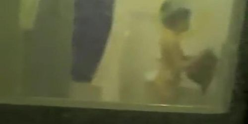 Girl shows her round titties to the window voyeurer