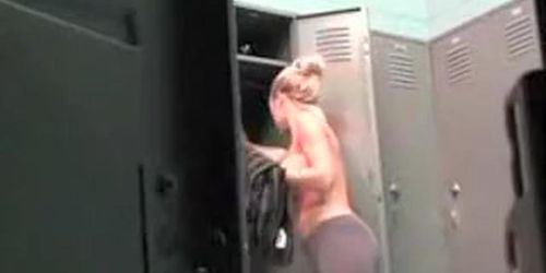 Fitness girl with fake boobs in locker room