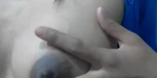 Squeezes out milk from her dark nip ttis