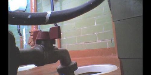 Girl in leather boots is getting spied pissing on toilet