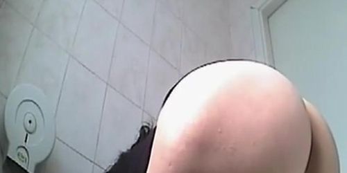 Brunette peeing in public toilet