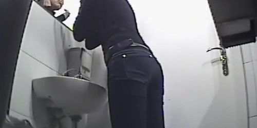 Pissing and fixing makeup in the mirror