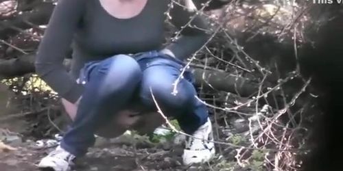 Two college girls squat and pee in the woods