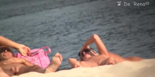 Bare pussy on a sandy beach exposed to crafty voyeur cameras