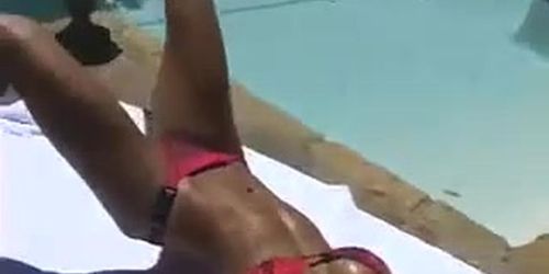 Ashley Lawrence sunbathing by the pool
