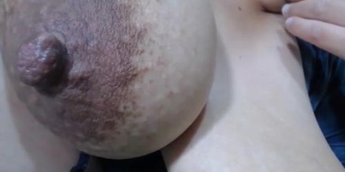 Giving you mouth watering with her big lactating boobs with areolas and dark nipples