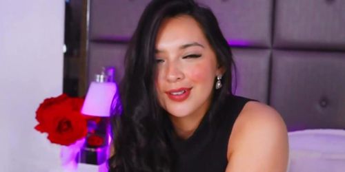 Dark haired girl sucks on her toy and fingers her slit