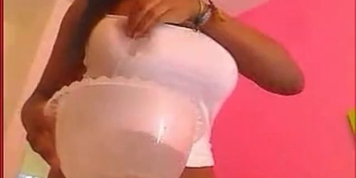 Big titty black babe stripteasing and seducing on webcam while playing with her big melons