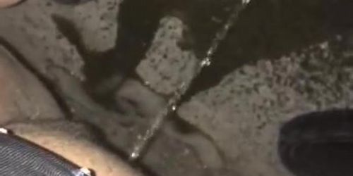 Dancer pees rough outside on concrete 