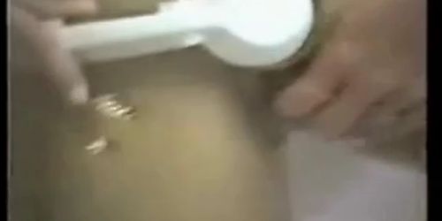 Hot girl with fake tits puts entire shower head in pussy