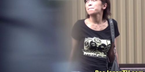 Asian girl pees in public street