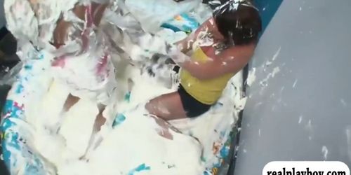 Coeds play tag of war soak in whipcream in inflatable pool