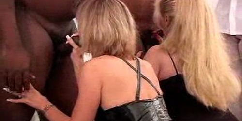 two women in interracial gangbang