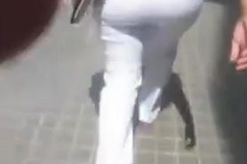 Hot street candid video of a mature women in white pants
