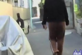 Asian girl in brown sweatpants gets a street sharking.