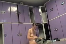 Naked female is sitting on the changing room bench