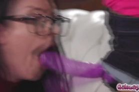 Kira pounded Angela's shaved pussy with a purple strapon