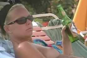 Hot video of a mature woman reading a book on a nudist beach