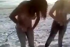 Two crazy naked girls on the beach