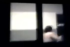 woman spied topless through window