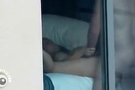 Our neighbors caught having sex through a hotel window