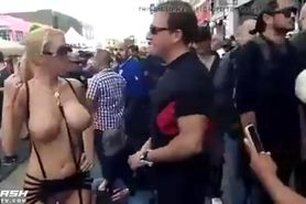 girl shows crowd her big boobs