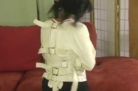 Angry girl struggles in a straitjacket