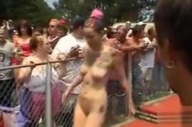 Large-breasted models pose and dance at an outdoor party