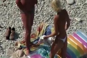 Couple undressing in beach