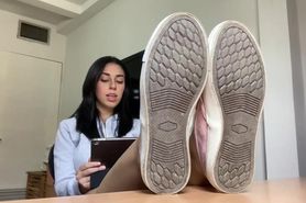 Latina shows feet while reading