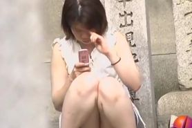 Sharking Japanese girl gets her small boobs seen