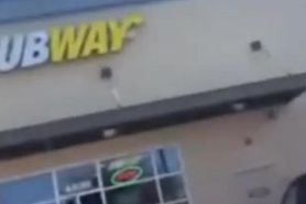 Dude getting head in front of subway