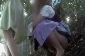 Women caught peeing in inclined ground