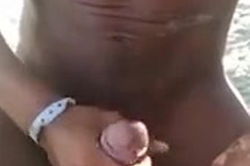 Black guy cums on MILF's feet on the beach
