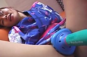 Kimono wearing Asian brunette plays with her toy