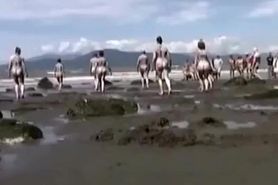 Naked performance art on the beach