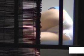 Asian girl dries out hair and masturbates on window spy cam