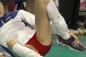 Pro sport girl stretches on the floor