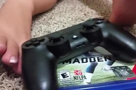 Girl with french pedicure playing with playstation controller with her sexy feet